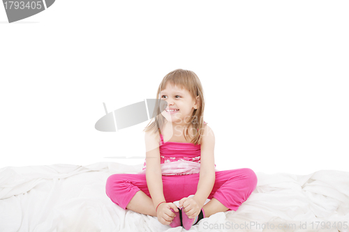 Image of Portrait of a cute little girl sitting on floor, isolated over w