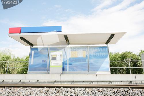 Image of Two blue billboards at a train stop