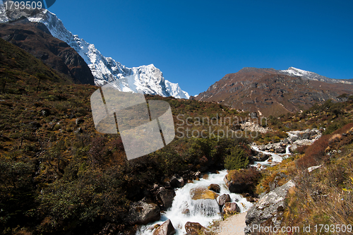 Image of Himalayas landscape: snowed peaks and stream