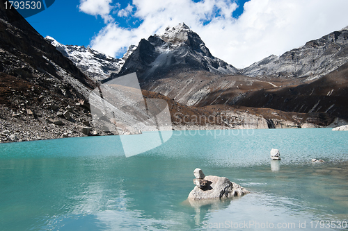 Image of Balance: Pebble stacks and Sacred Lake near Gokyo