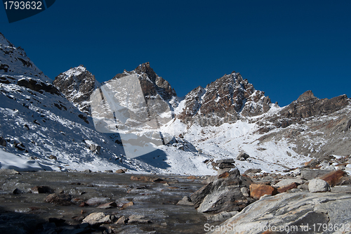 Image of Renjo pass: mountain peaks and stream in Himalayas