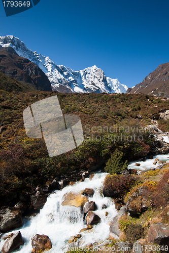 Image of Himalaya landscape: snowed peaks and stream