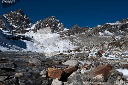 Image of Renjo pass: mountain peaks and stream in Himalayas