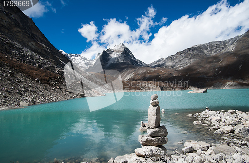 Image of Harmony and balance: Pebble stack and Sacred Lake in Himalayas