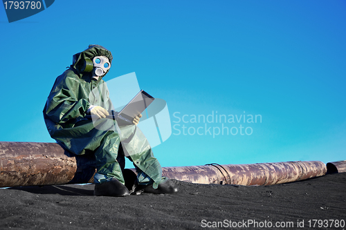 Image of Scientist with a laptop on chemically contaminated area
