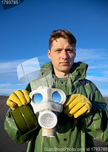 Image of Man in a overalls with a gas mask