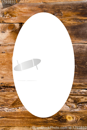 Image of Old wooden building wall and white oval in center  