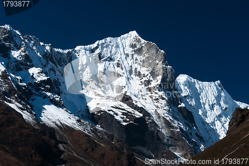 Image of Snowbound mountain range and blue sky in Himalayas