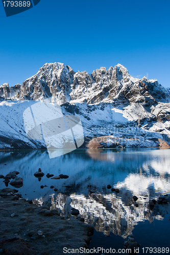 Image of Mountains and reflection in Sacred Gokyo Lake in Himalayas