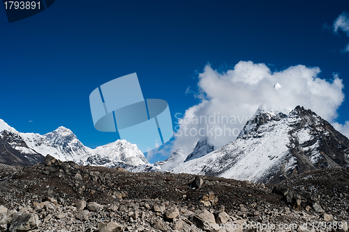 Image of Peaks and clouds near Sacred Lake of Gokyo in Himalayas