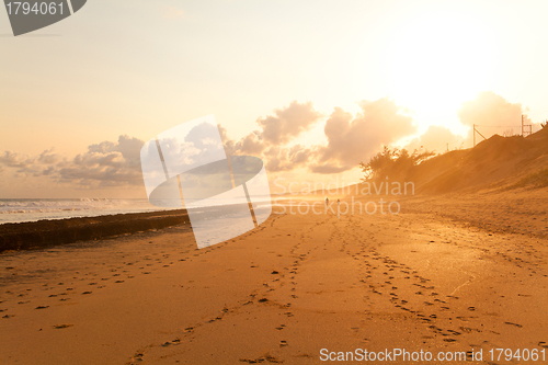 Image of couple taking a walk on beach in sunset 