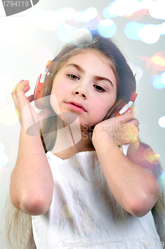 Image of child with headphones listebing to music