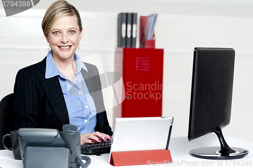 Image of Cheerful female secretary typing document