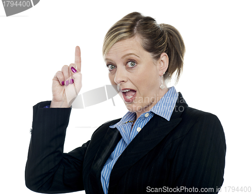 Image of Shocking corporate woman pointing upwards