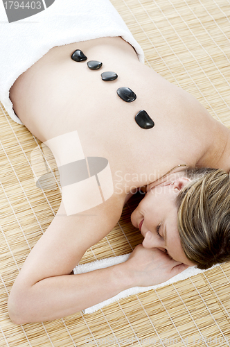 Image of Aerial view of woman during hot stone massage