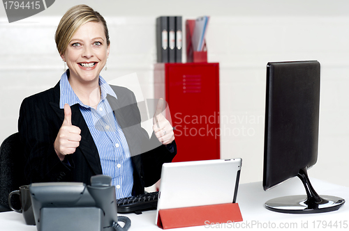 Image of Senior businesswoman gesturing thumbs up