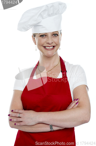 Image of Smiling female cook with crossed arms