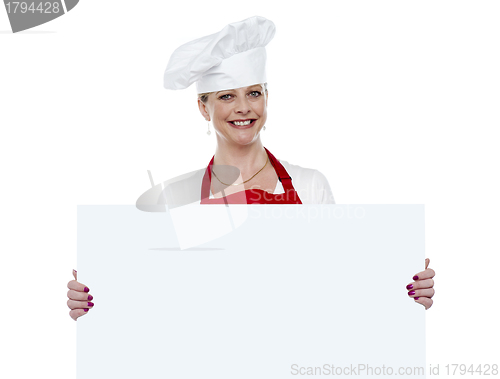 Image of Matured cook presenting blank billboard