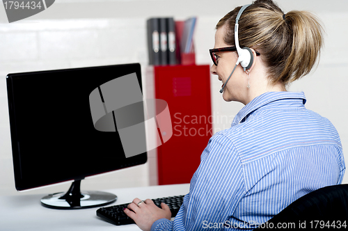 Image of Back view of help desk lady working