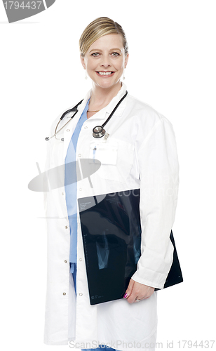 Image of Smiling female surgeon carrying x-ray report