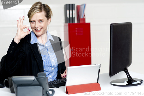 Image of Female executive showing excellent gesture