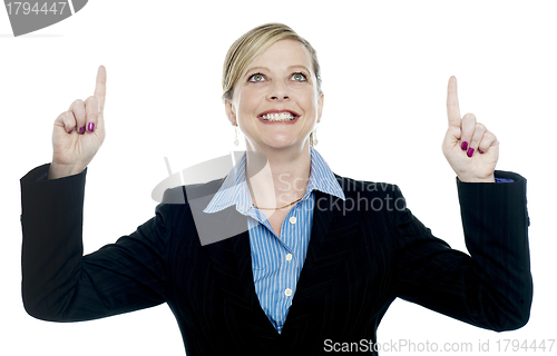 Image of Corporate lady pointing upwards with both hands
