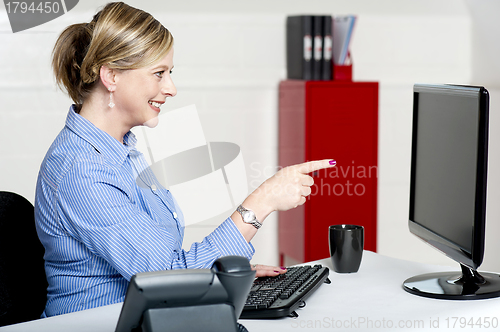 Image of Businesswoman pointing at computer screen
