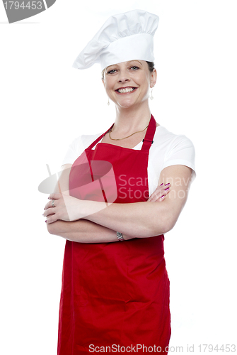 Image of Confident female chef posing with crossed arms