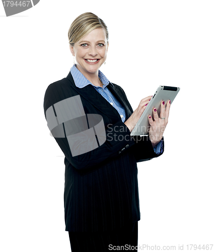 Image of Smiling corporate woman using wireless tablet pc