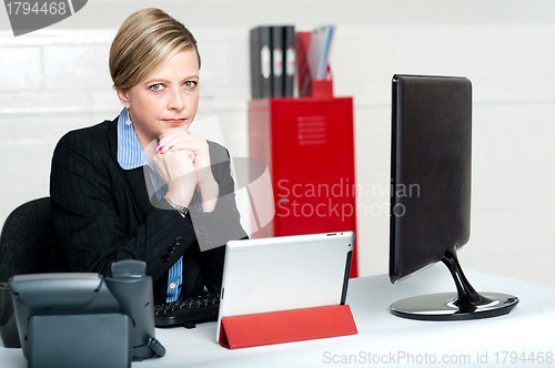 Image of Serious business lady looking right into camera