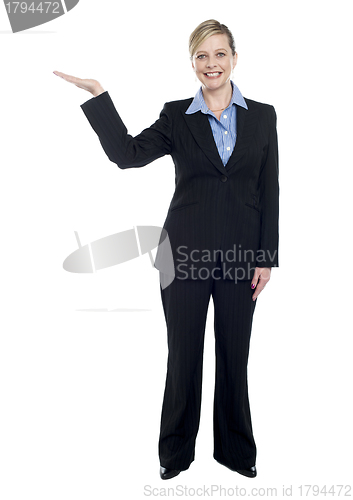 Image of Smiling corporate lady presenting copy space