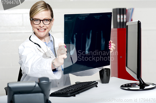 Image of Experienced female physician holding x-ray