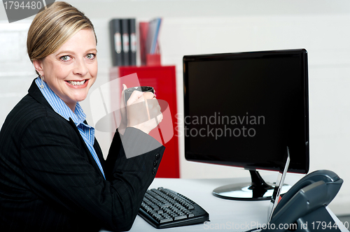 Image of Corporate lady enjoying coffee during break