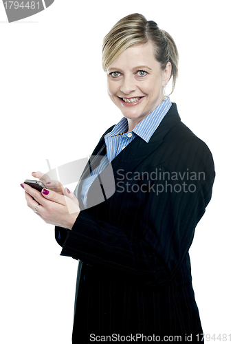 Image of Smiling corporate lady using cellphone