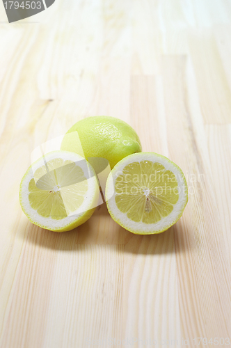 Image of fresh lemon  over pinewood table