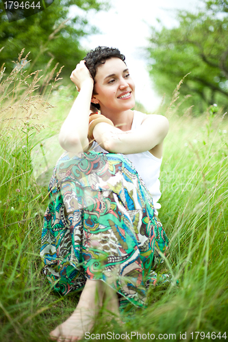 Image of girl resting on fresh spring grass 