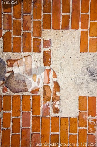 Image of Fragment of ancient red brick wall with stones ant cement in it. 