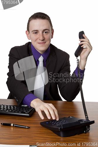 Image of  Businessman dialing telephone number