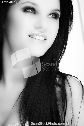 Image of Closeup of a cheerful young woman smiling