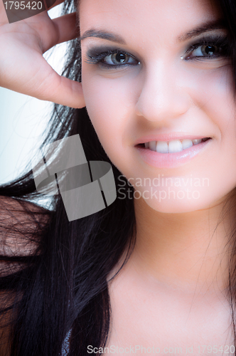 Image of Closeup of a cheerful young woman smiling