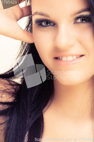 Image of Closeup of a cheerful young woman smiling