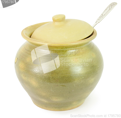 Image of Old ceramic pot with a spoon