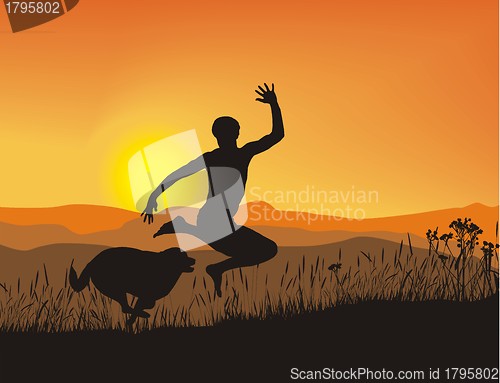 Image of Antics boy and dog at sunset in the mountains