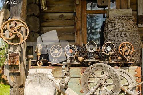 Image of Old sewing and weaving machines tools log house 