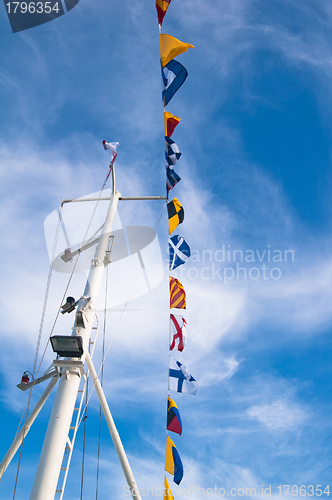 Image of Mast with the navigating equipment of a yacht and alarm flags