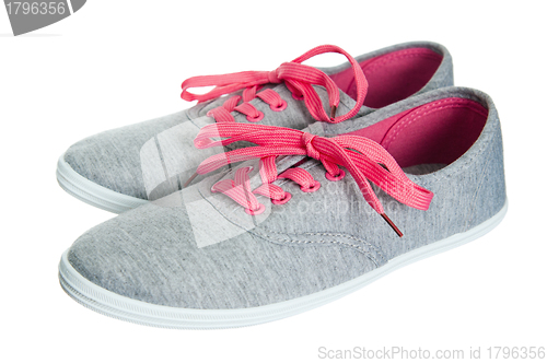 Image of Beautiful female pink sneakers, it is isolated on white
