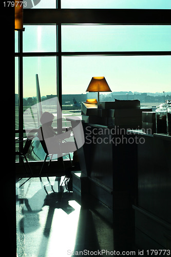 Image of Woman reading at the airport
