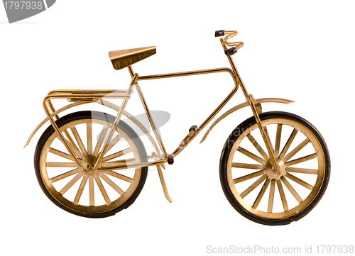 Image of Small gold color toy bicycle isolated on white 