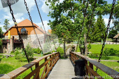 Image of Rusty chains hold bridge in park 