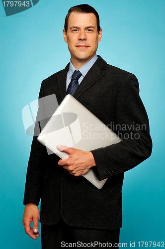 Image of Businessperson carrying a laptop